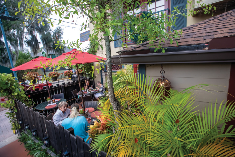 Visitors dine outdoors at The Goblin Market Restaurant and Lounge in downtown Mt. Dora, Florida. 