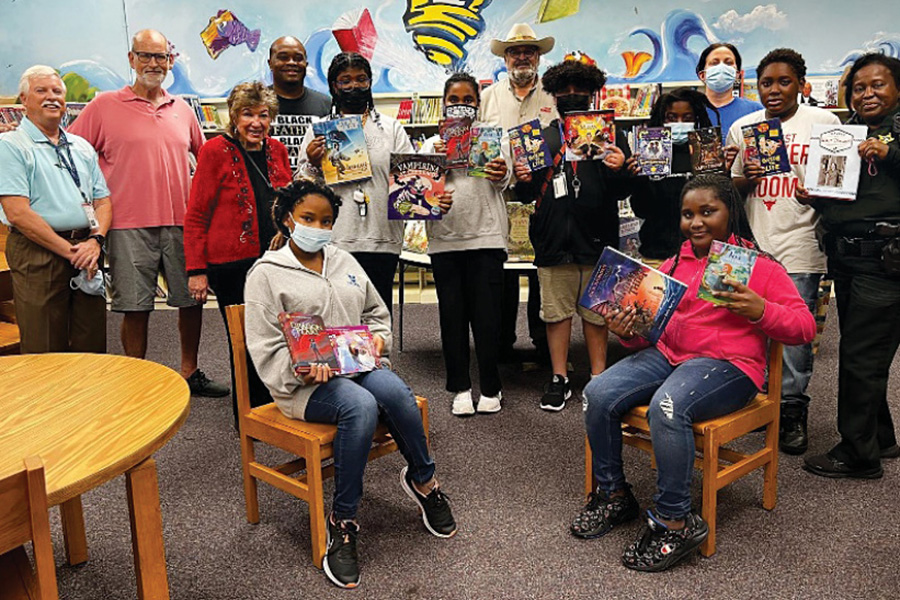 Kids holding books at the Pompano Elementary School library