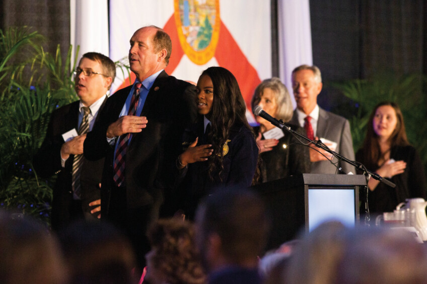 FFA representative leads the Pledge of Allegiance at the hall of fame banquet