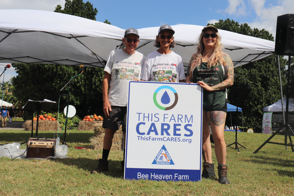 Bee Heaven Farm family with their This Farm Cares sign