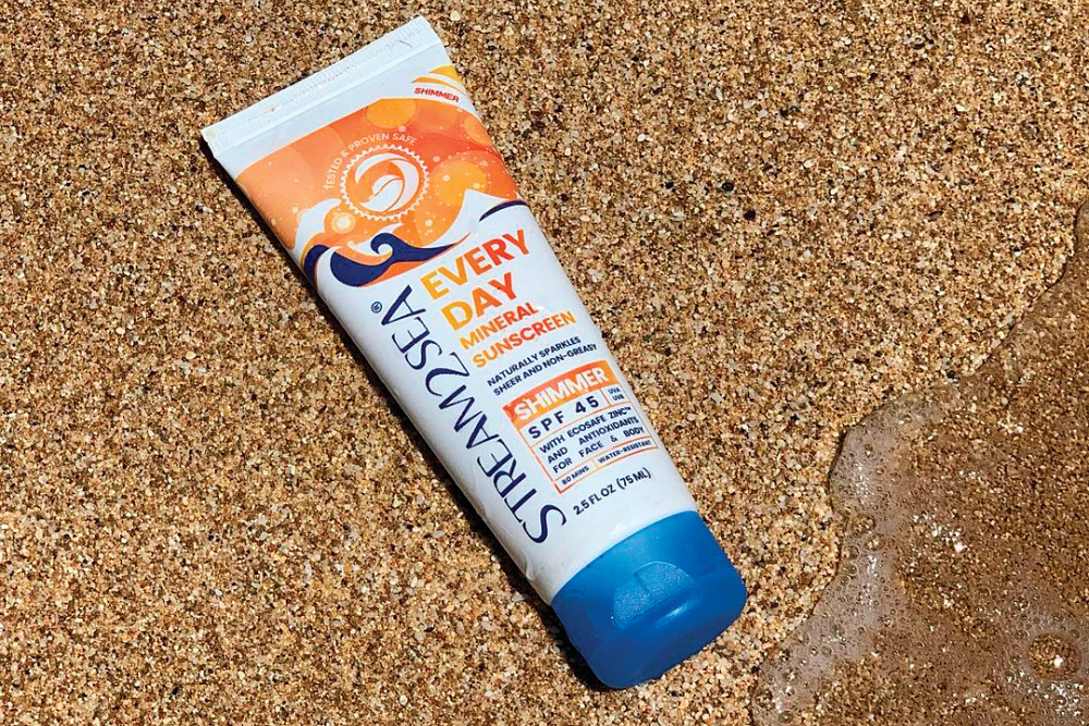Stream2Sea sunscreen laying on beach